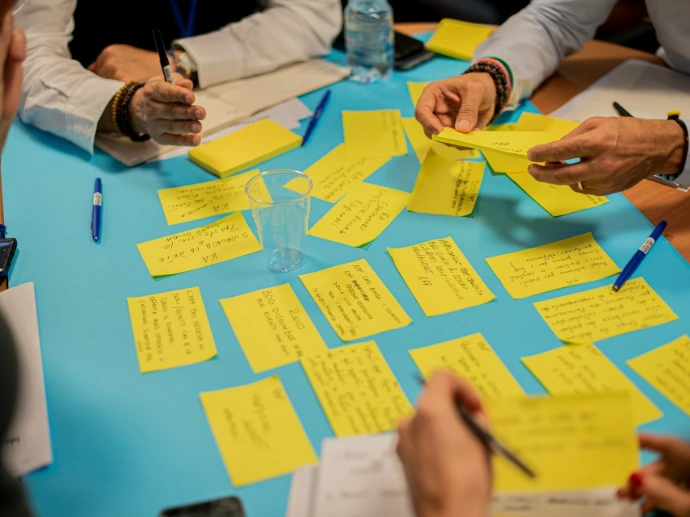 person holding yellow sticky notes